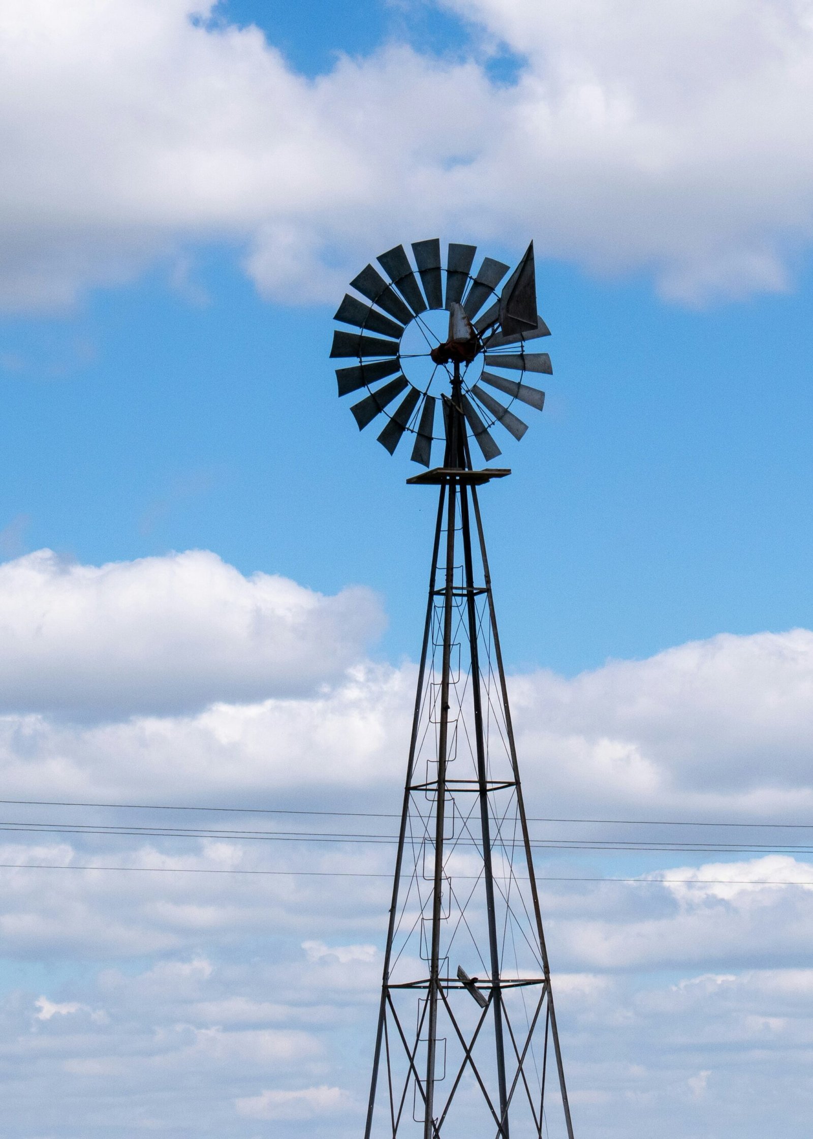 Windmill for Clean and Renewable Energy Traditional windmill against blue sky with clouds representing renewable energy